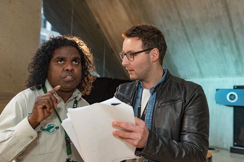 Voice coach with actor on film set