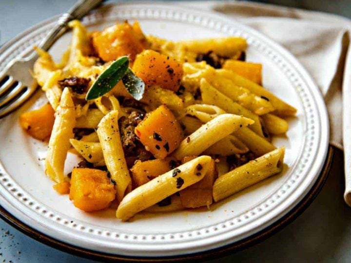 Butternut Squash Italian Sausage Pasta Bake on a white plate with fork