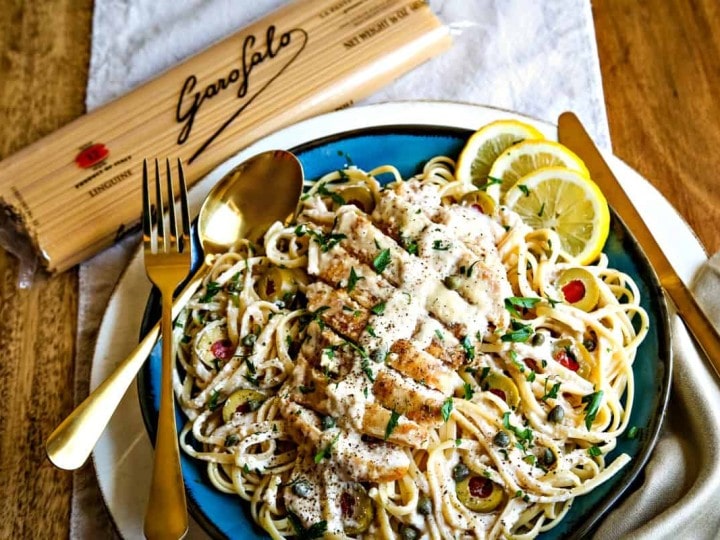 linguini with chicken in a lemon parmesan sauce on a blue plate