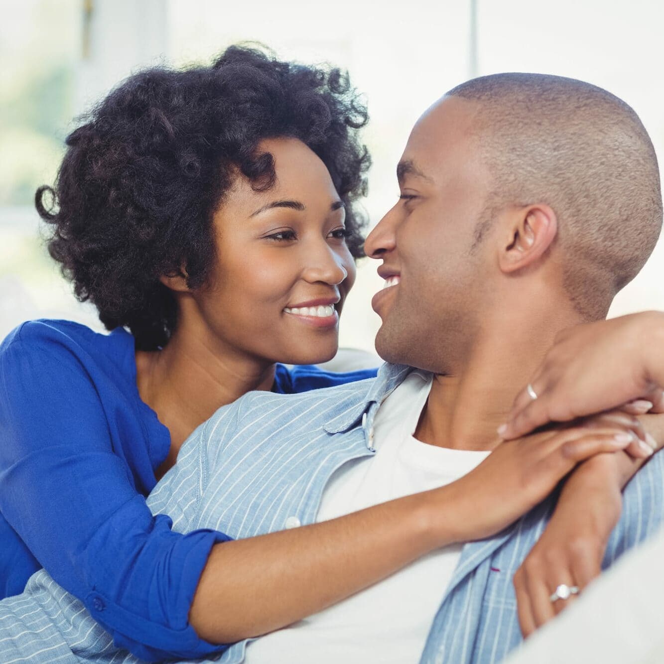 Portrait of smiling couple on the sofa looking at each other
