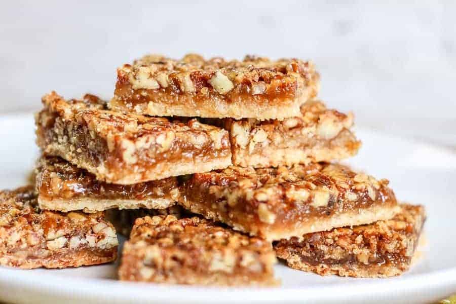 The BEST Pecan Pie Bars for your holiday dessert table! These pecan pie bars are my family's favorite pie bar! Watch them disappear as soon as you set them on the table! #pecanpiebars #mooreorlesscooking #piebar #bar #recipe #bake #food via @Mooreorlesscook