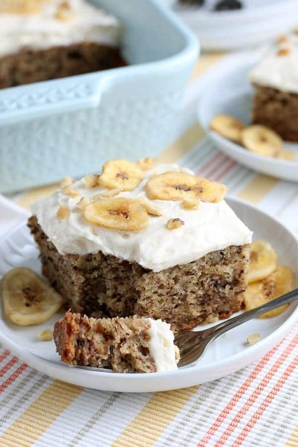 The Best Banana Walnut Cake is topped with a thick and creamy cream cheese frosting. It's baked up perfectly in a 13 x 9 baking dish with the best banana flavor, that is so soft & moist, and just crazy delicious. Optional garnish with sliced fresh bananas or banana chips and chopped walnuts for an amazing dessert! via @Mooreorlesscook