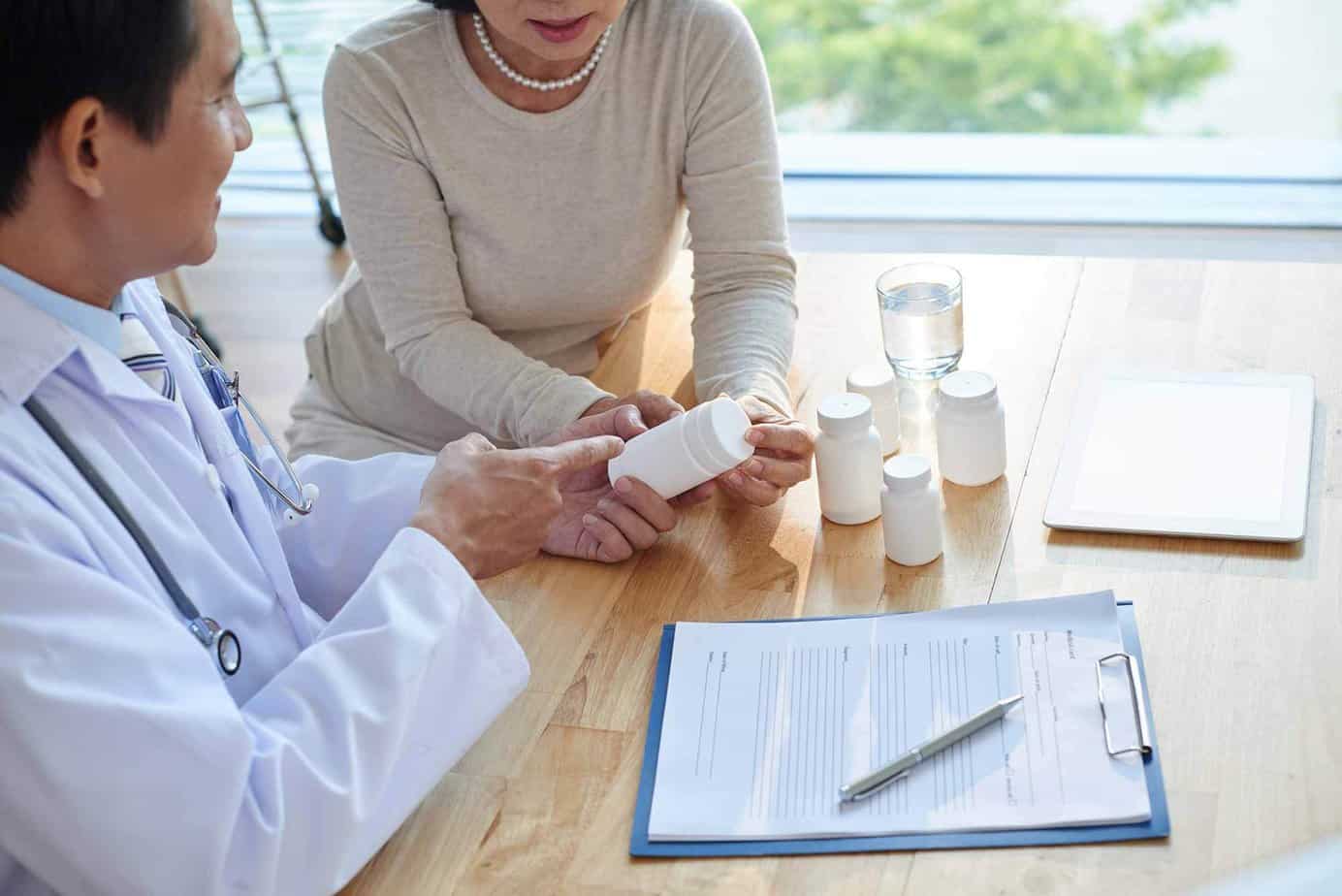 psychiatrist reviewing prescription pills