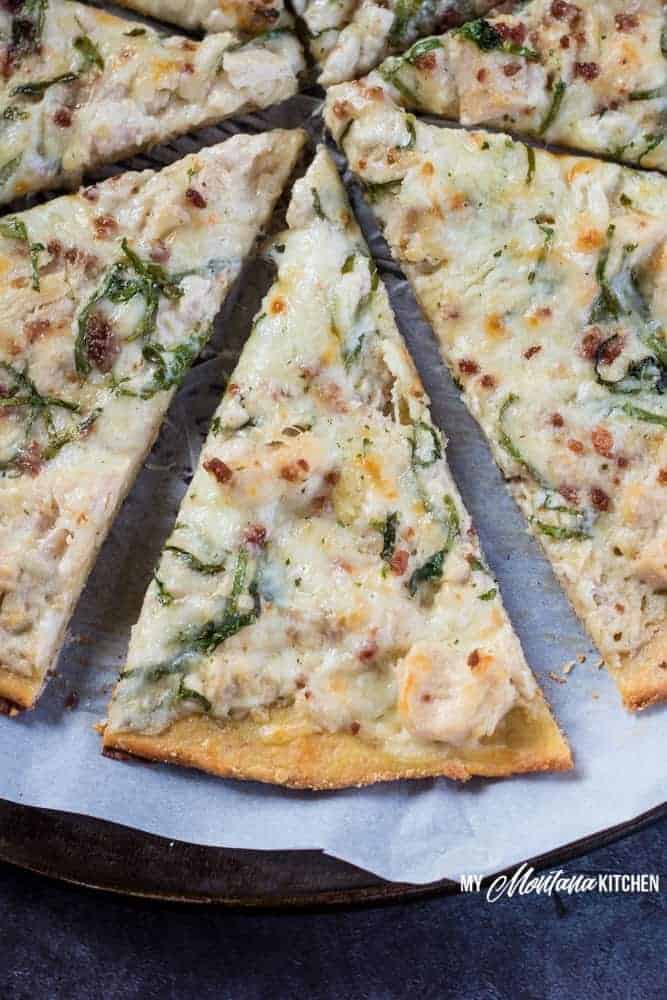 This low carb Chicken Alfredo Pizza recipe is a satisfying (and delicious!) gluten free pizza that you're going to want to make again and again. Just because you're eating low carb, doesn't mean you have to sacrifice your favorite foods. With the perfect low carb crust and creamy parmesan garlic sauce, this Chicken Alfredo Pizza makes a great low carb family dinner! #pizza #lowcarbpizza #ketopizza #alfredo #alfredopizza #lowcarb #keto