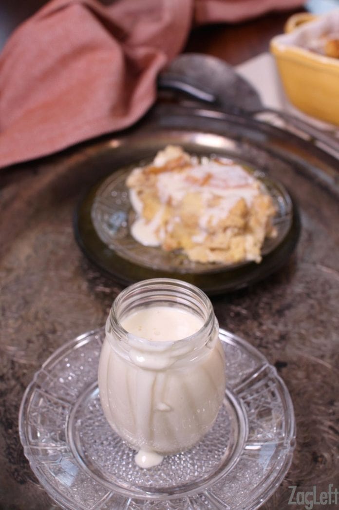 whiskey sauce in a jar next to a plate of bread pudding | one dish kitchen
