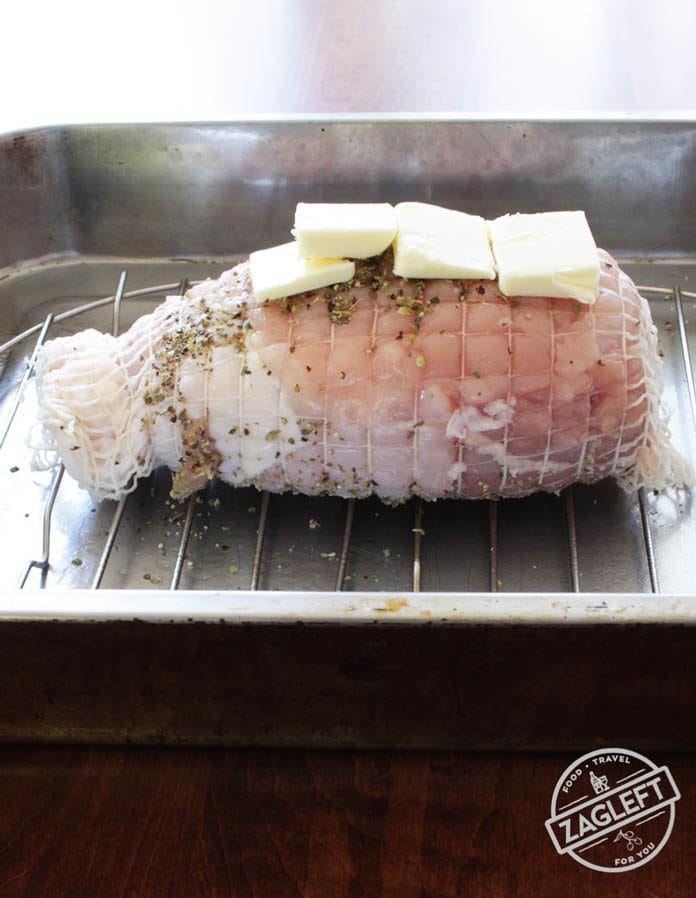 a raw turkey roast in a roasting pan | OneDishKitchen