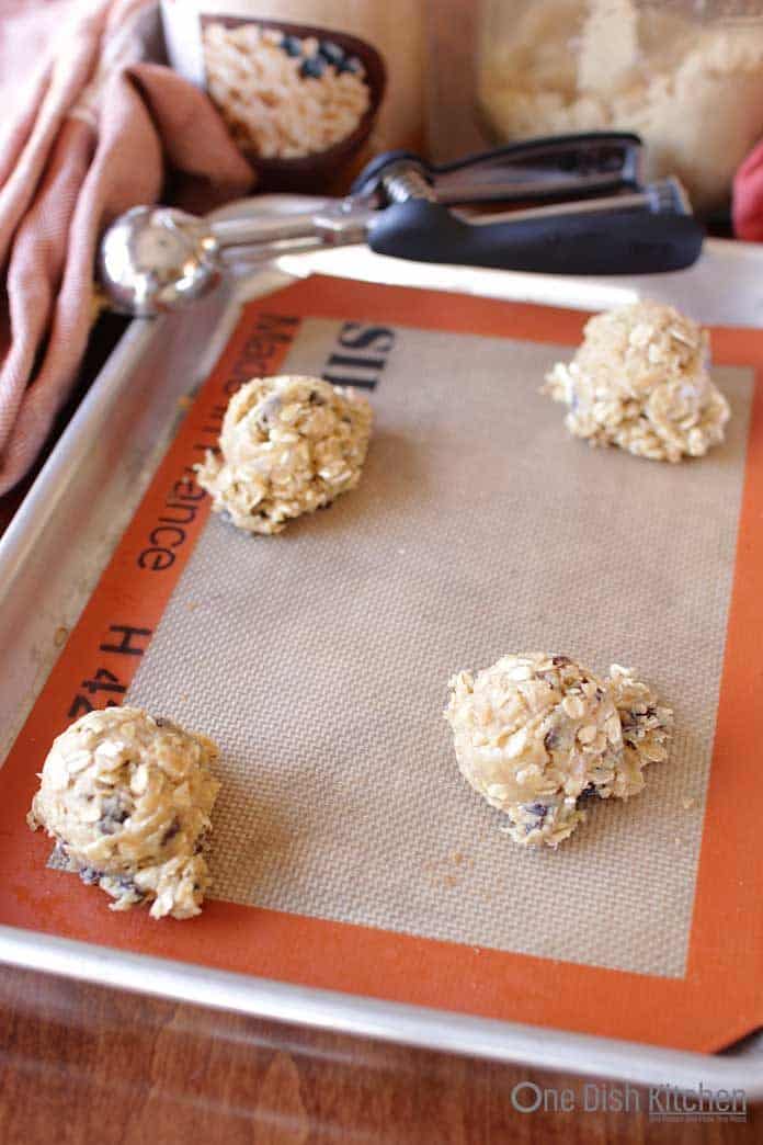 Oatmeal cookie dough on a baking sheet | One Dish Kitchen
