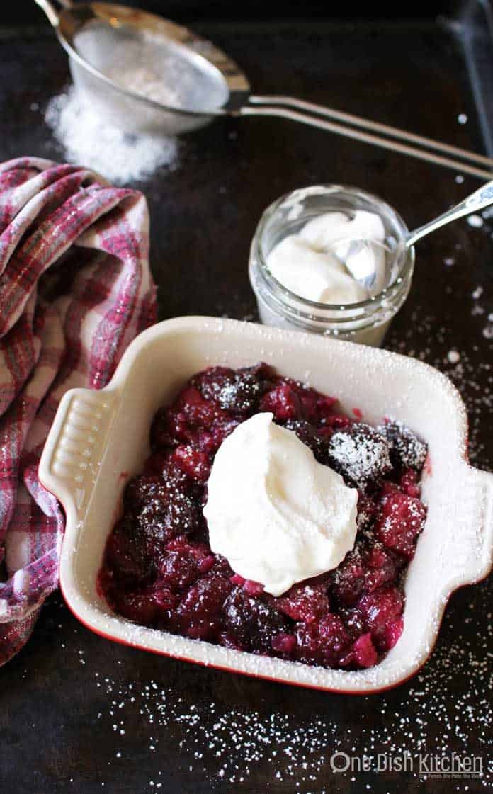 a small cherry pie with whipped cream.
