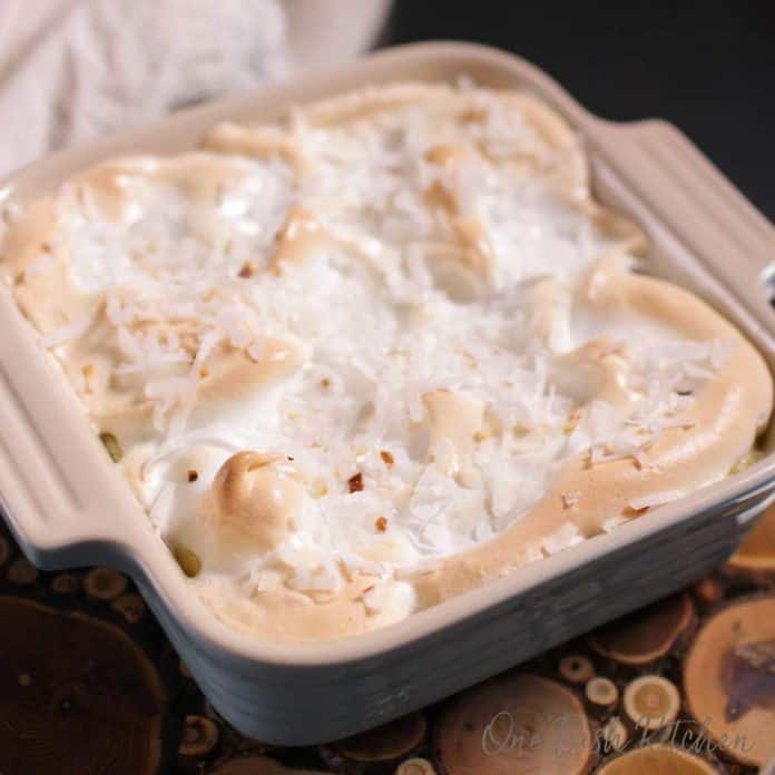 a mini coconut cream pie topped with meringue and toasted coconut | one dish kitchen