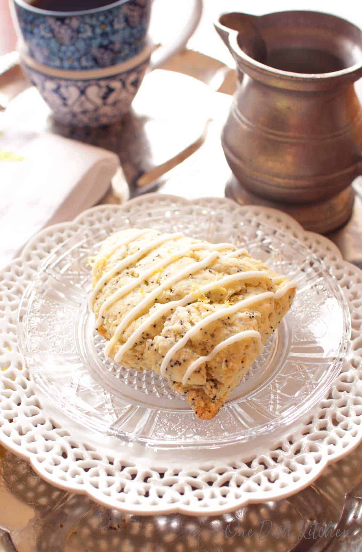 one lemon glazed scone on a plate near a cup of coffee | one dish kitchen
