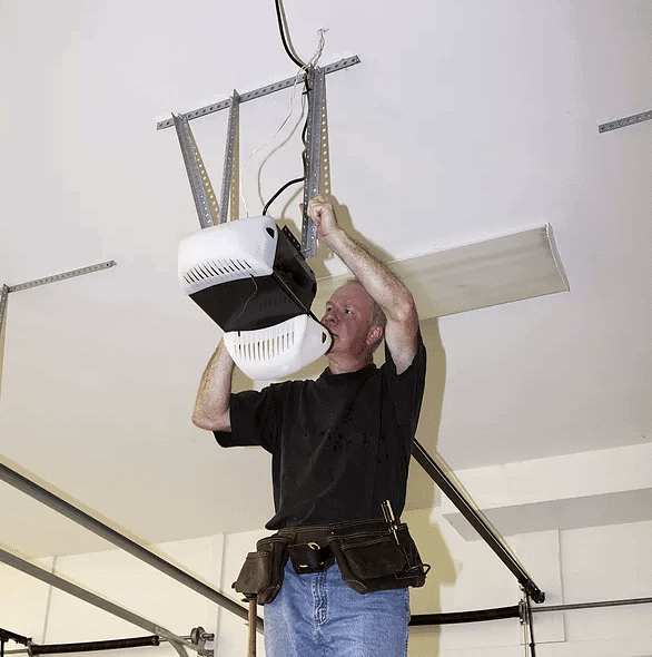 man repairing a garage door opener man repairing a garage door opener