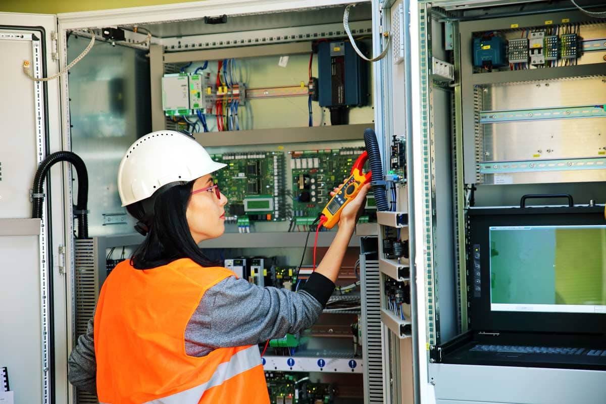 testing-electrical-equipment-spike-electric Worker testing electrical equipment at Spike Electric