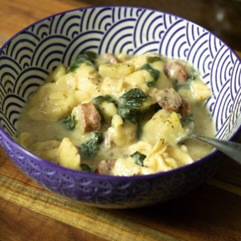 close up of spinach sausage and tortellini soup