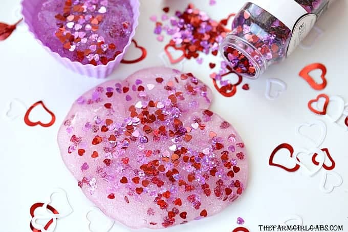 You and your kids will LOVE making this easy DIY Valentine's Day Slime project. This fun craft makes a great party favor too!