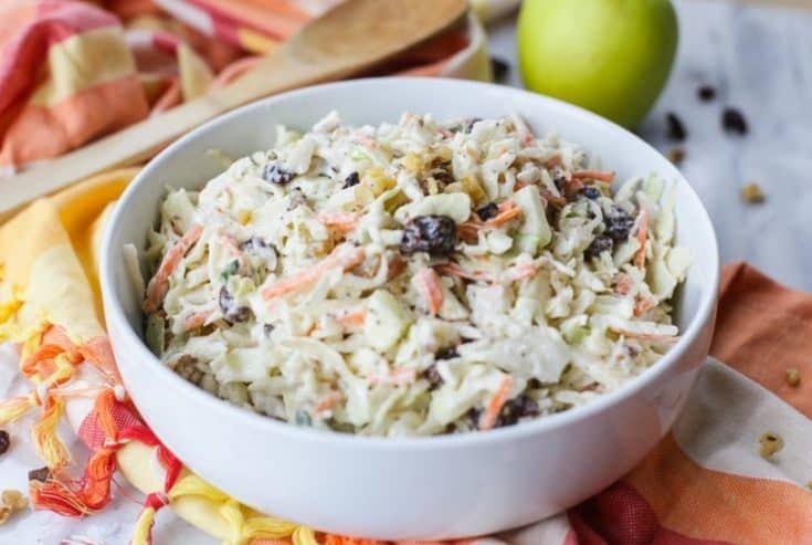 Coleslaw isn't just for picnics. Take your coleslaw to a new level with this tasty Apple Raisin Coleslaw. This southern coleslaw recipe is the perfect side dish to serve any time of year. Ready in just 10 minutes, this delicious coleslaw recipe is topped with a creamy homemade dressing. It's the perfect blend of sweet and savory. #coleslaw #easyrecipe #southerncoleslaw