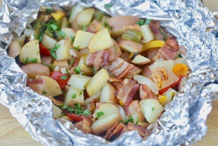 Fire up the grill and make this Potato And Bacon Foil Packets recipe. This easy grilled side dish is a perfect summer recipe or camping recipe. And it has bacon in it! #foilpackets #potatoandbaconfoilpacket #campingrecipe #grillingrecipe #Ad #BTBGrillingRecipes #IC