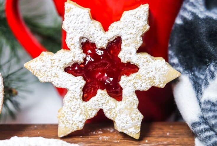 This Classic Linzer Cookies recipe will totally be your jam (no pun intended). Win your Christmas Cookie Swap with this delicious cookie recipe. This traditional Linzer sandwich cookie recipe is full of buttery almond flavor and filled with sweet raspberry jam. #chrismtascookie #cookieswap #linzercookies