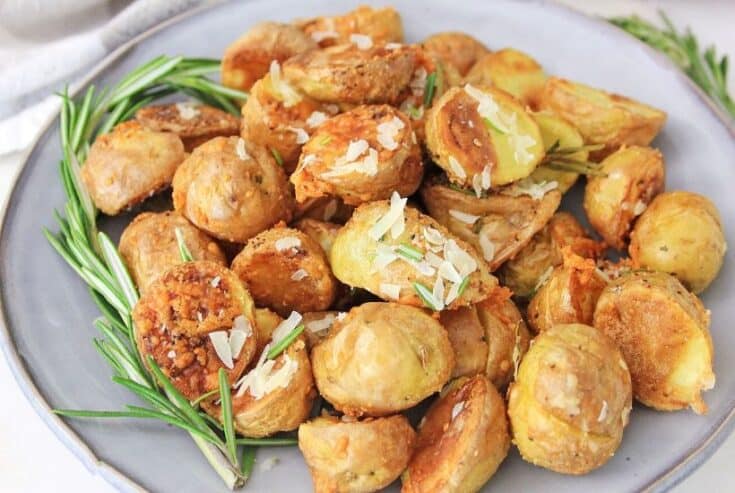 Lighten up your side dish routine with this easy Air Fryer Parmesan Rosemary Potatoes. This is a delicious weeknight or holiday side dish. We all love potato recipes and this potato recipe is quick and easy. This air fryer recipe is a healthier version of the classic roasted potatoes. Your family will love this healthy air fryer potato recipe. #potatorecipe #airfryerrecipe #airfryer #healthyrecipe