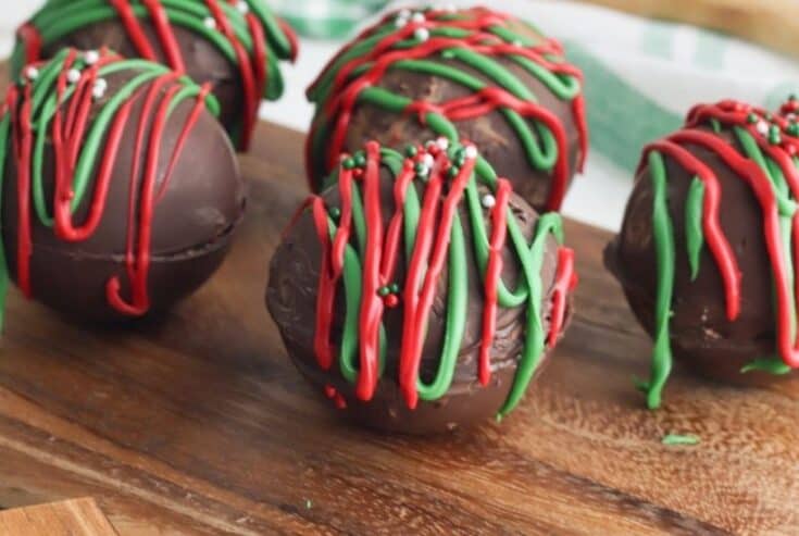 Ready for an indulgent treat? This Hot Chocolate Bombs Recipe is rich and filled with hot chocolate, marshmallow and sprinkle surprises inside. What is a hot chocolate bomb? A Hot cocoa bomb is a chocolate shell that is filled with hot cocoa, marshmallows and other hot chocolate add ins. Download the free Christmas printable gift bag toppers and give these as a Christmas food gift.