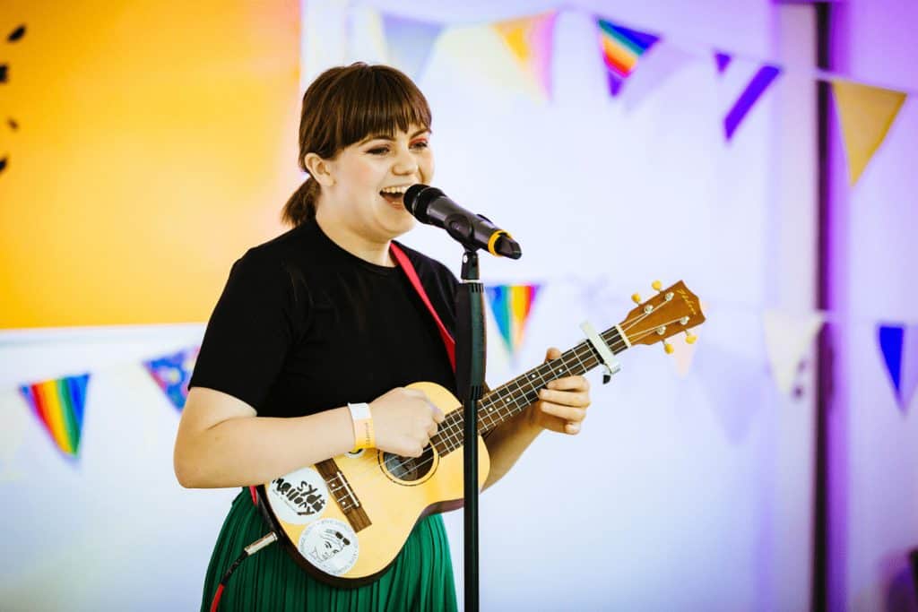A girl singing and playing guitar