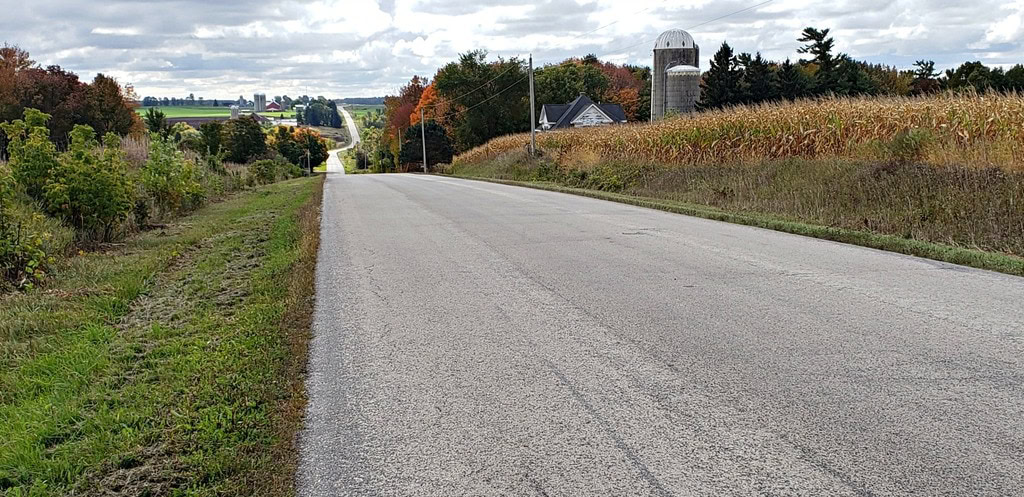 road winds over hills to distant horizona