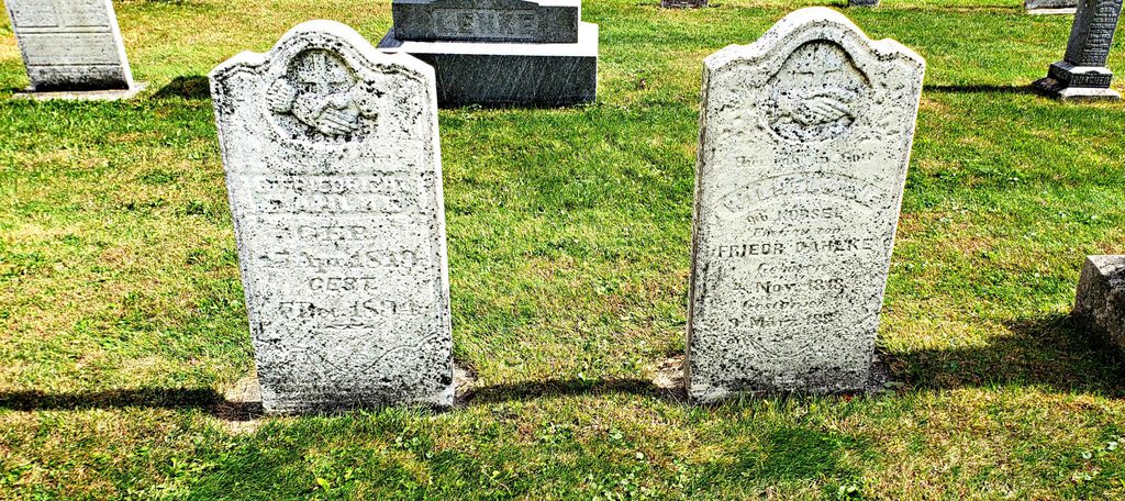 two old worn headstones reveal birthdates of 1819 and 1818