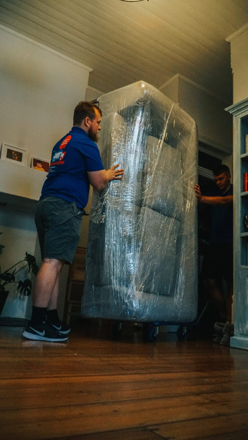 Victor-40 ABC Removalist moving wrapped furniture on dolly