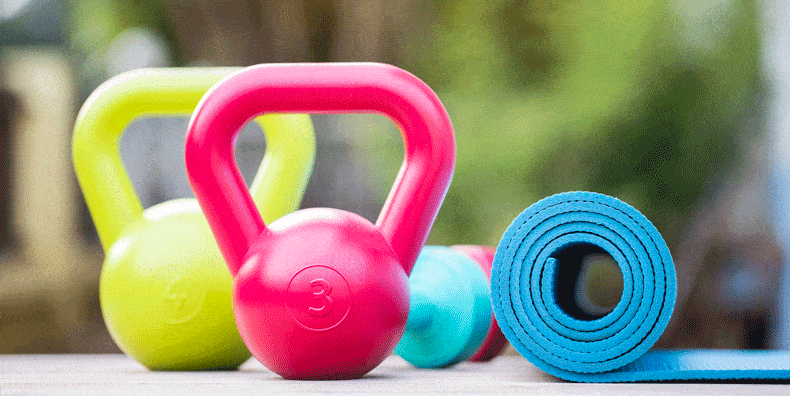Kettlebells, dumbbells and exercise mat for home gym