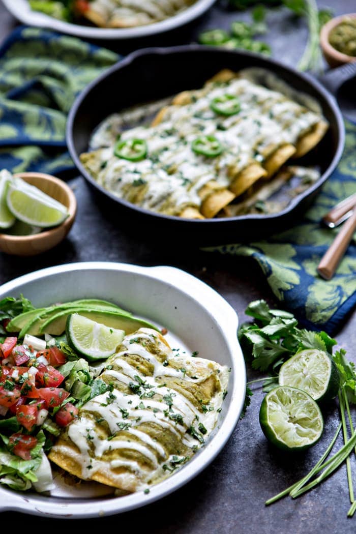 green enchiladas smothered in sour cream sauce and tomatillo sauce