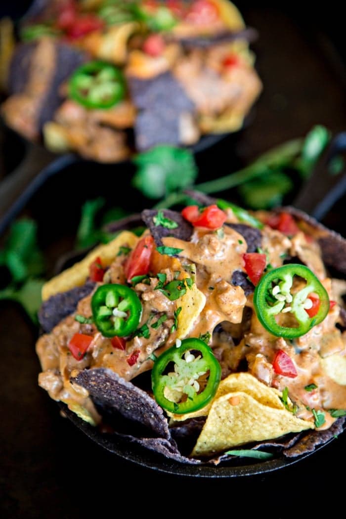 crock pot queso atop tortilla chips