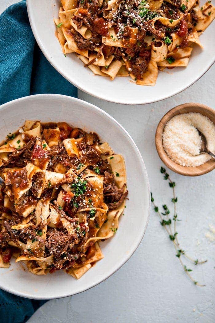 two bowls of beef ragu with fresh pasta