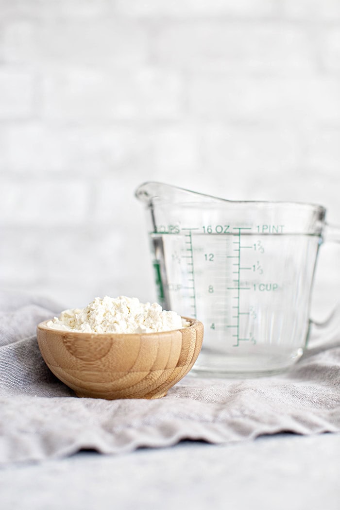 buttermilk powder and measuring cup of water