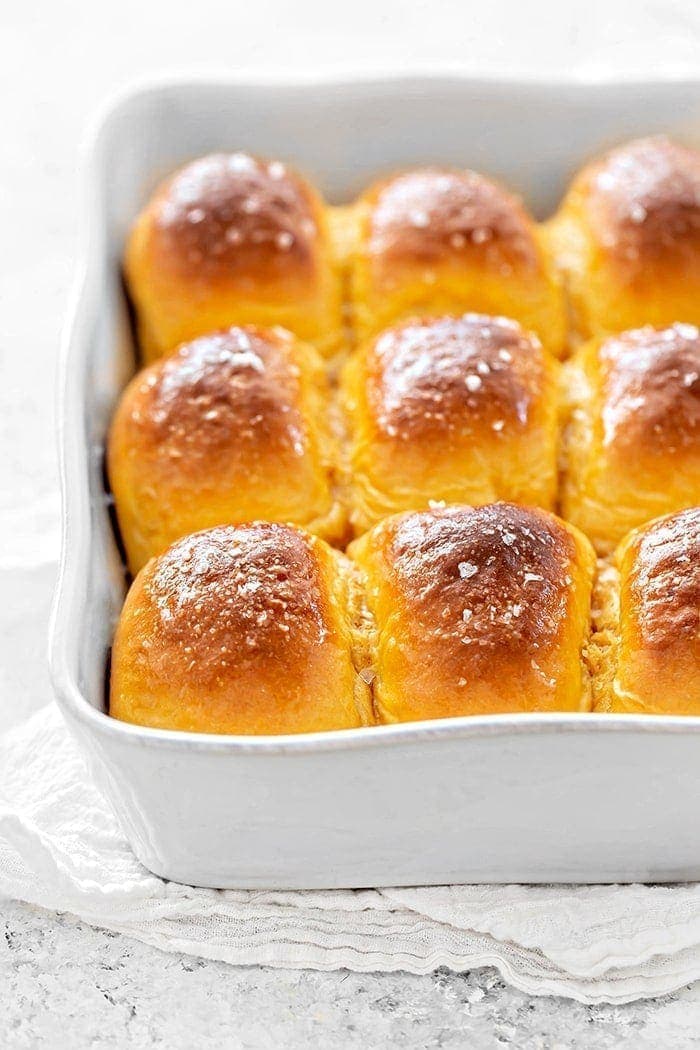 sweet potato dinner rolls in a white baking dish