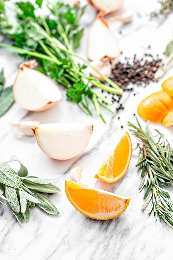 orange slices and fresh herbs on white background
