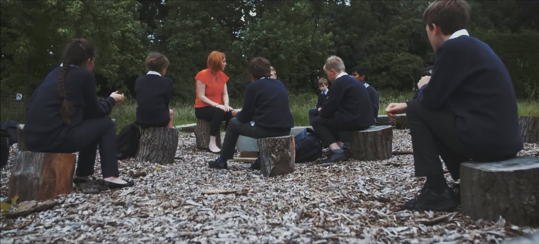 kids seating in the woods