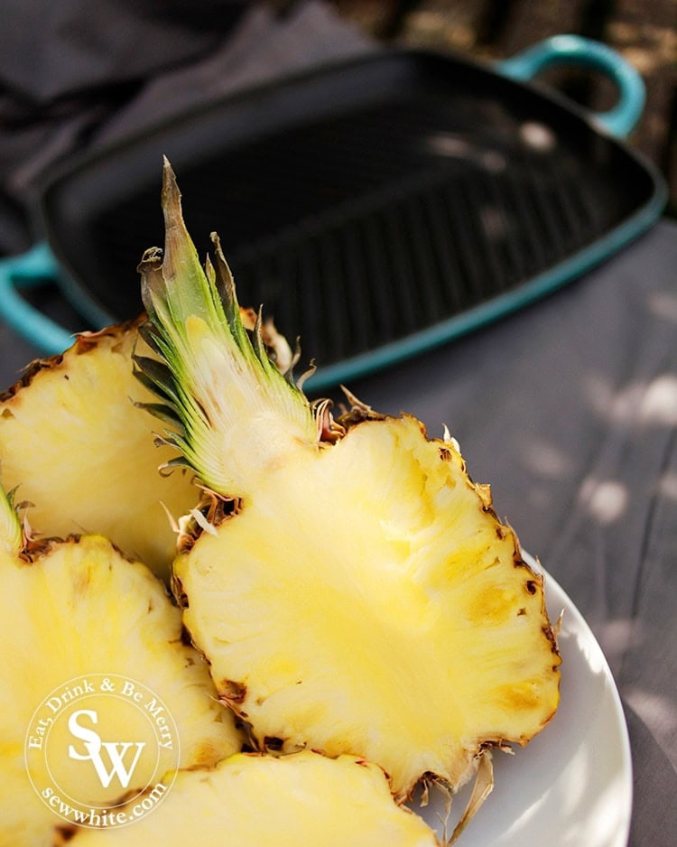 Fresh golden pineapple sliced in half ready to be grilled on the camp fire.