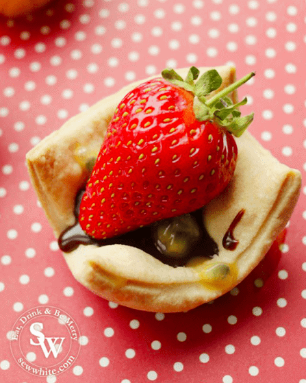 golden strawberry chocolate bites with chocolate and passion fruit and a strawberry