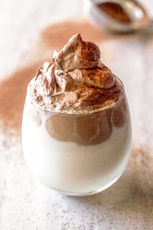 dalgona style whipped chocolate milk sprinkled with chocolate powder
