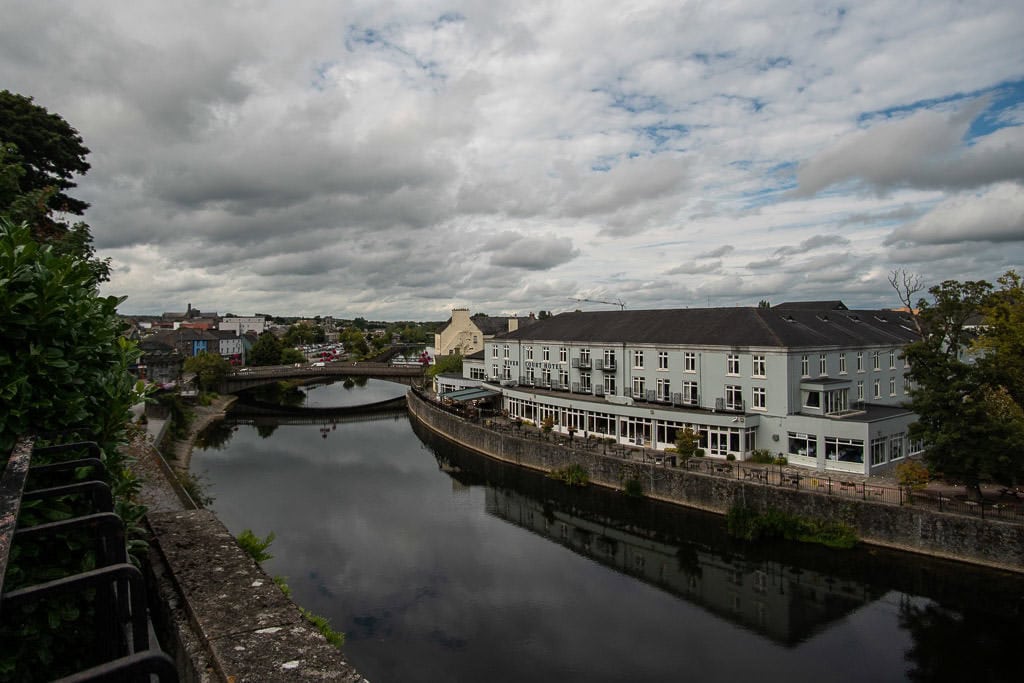Reflections of a large building on the river in Kilkenny