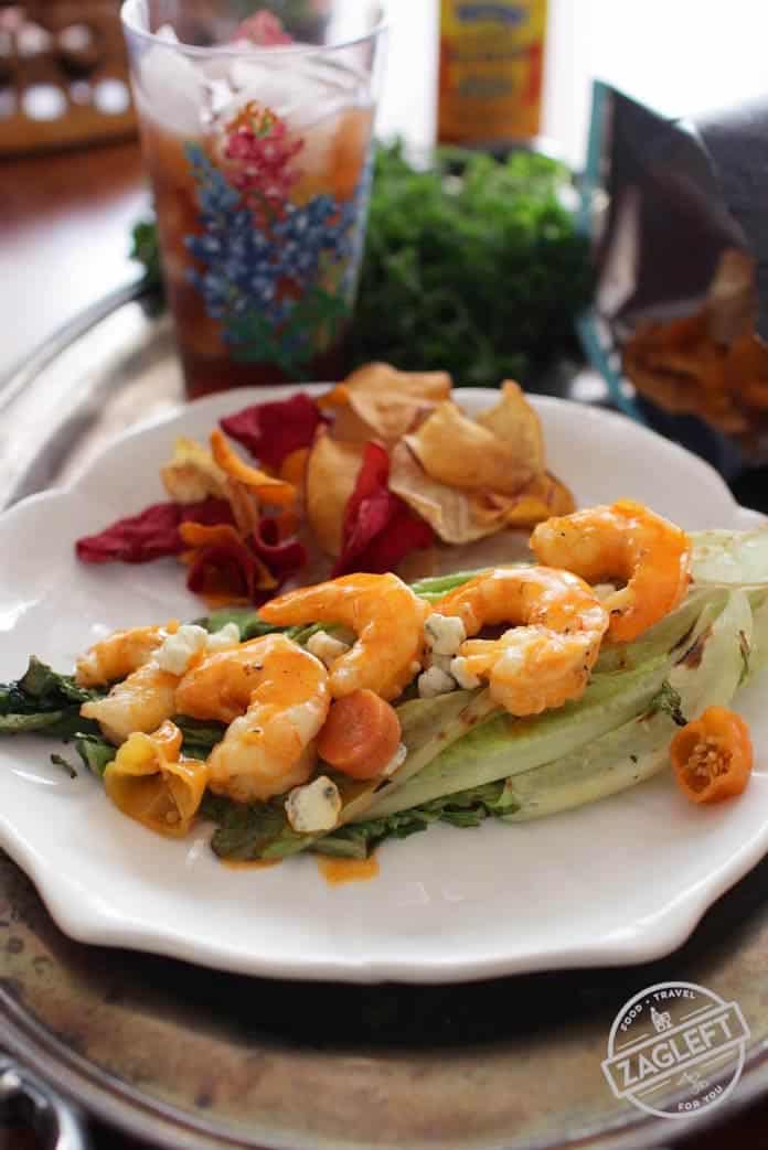 Grilled Buffalo Shrimp on grilled Romaine lettuce on a plate - zagleft.com