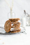 stack of oamteal molasses cookies with a glass of milk