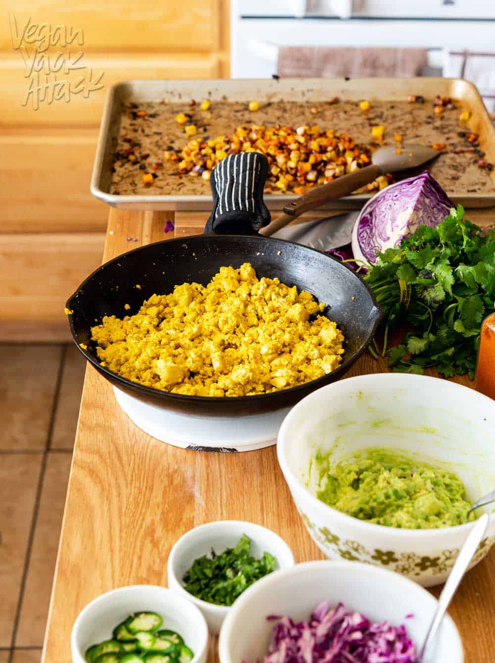 Image of taco fillings laid out on a wood kitchen island