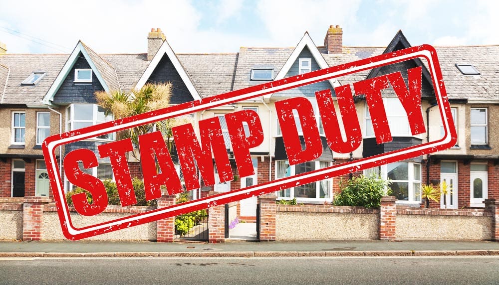 red stamp duty sign over row of houses