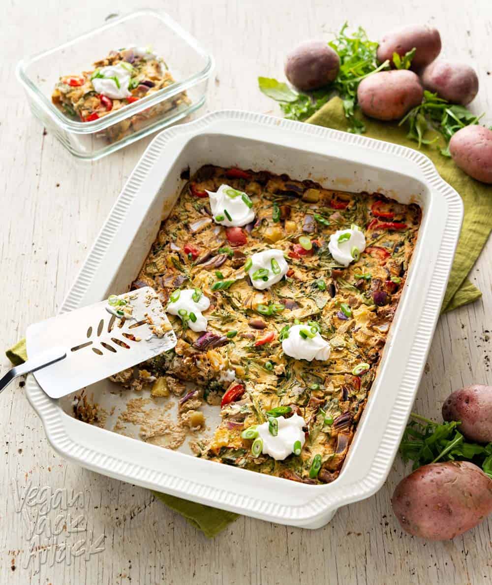 An image of a casserole in a large baking dish, on a wood background with green linen