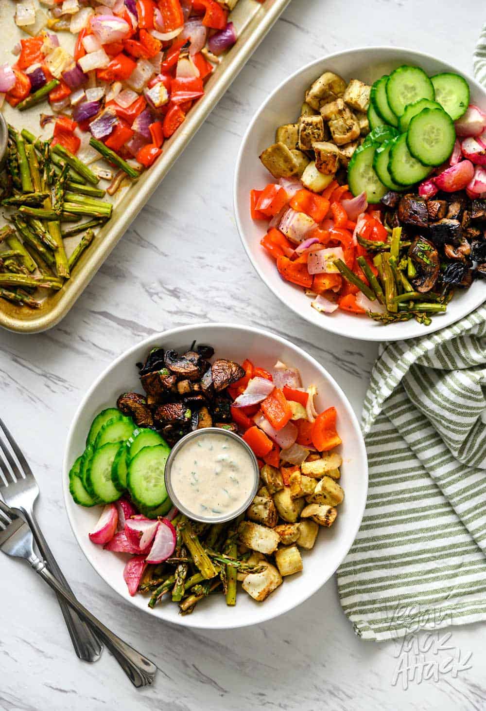 Image of two bowls, filled with a Mediterranean Sheet Pan Meal, and sauce, next to a sheet pan, with text overlay