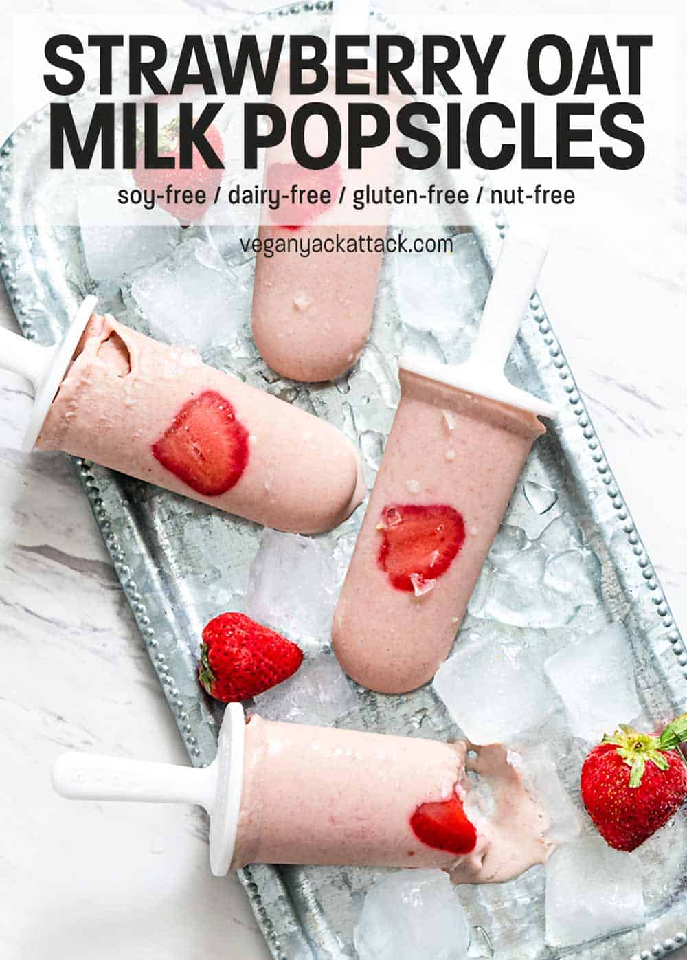 Strawberry Oat Milk Popsicles on a metal platter with ice cubes