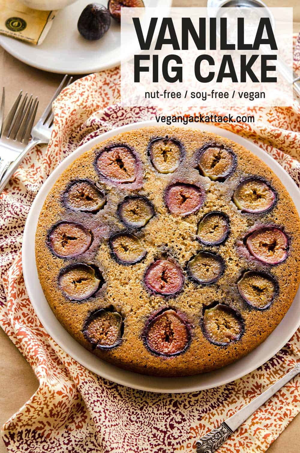 Vanilla Fig Cake Vanilla cake with figs baked into it on a plate with colorful linen