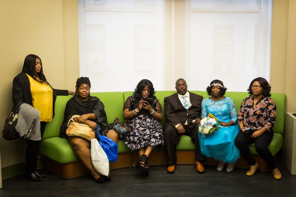 Couple and family waiting for an article on How to Get Married at City Hall in Any NYC Borough