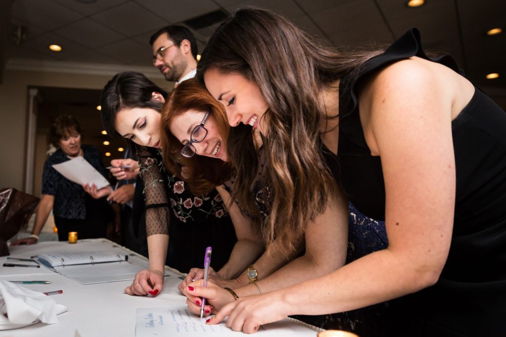 Guests filling out cards at a Larchmont Shore Club wedding