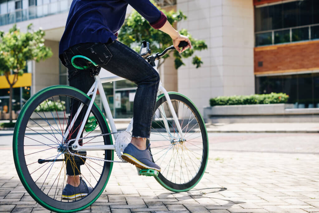 Cropped image of man sitting on bicycle and ready to ride